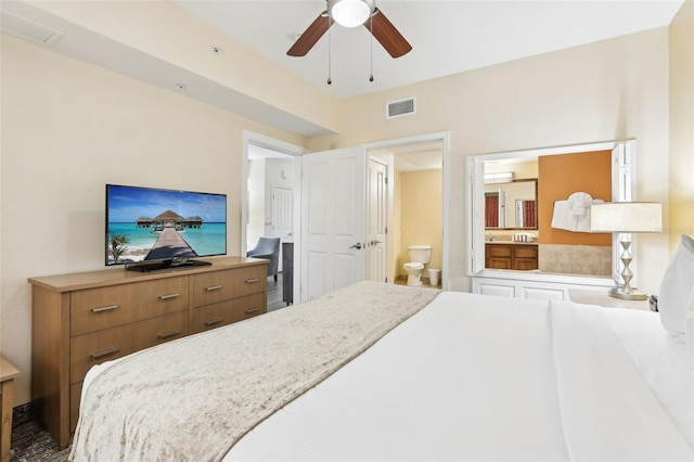 bedroom with visible vents, ensuite bathroom, and a ceiling fan