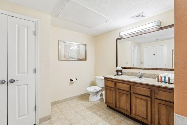 bathroom featuring visible vents, baseboards, toilet, tile patterned floors, and vanity