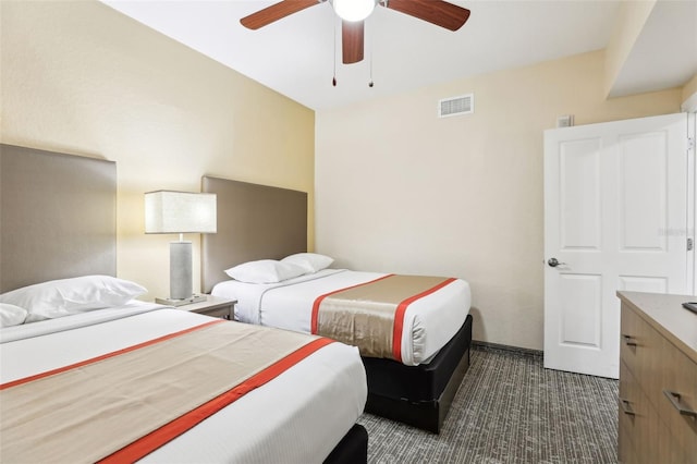 bedroom with a ceiling fan, visible vents, and dark colored carpet