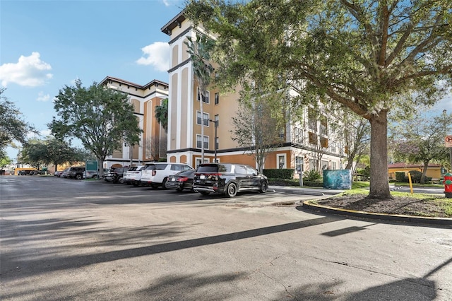 view of building exterior with uncovered parking