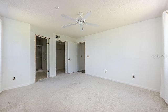 unfurnished bedroom with visible vents, baseboards, carpet, and a textured ceiling