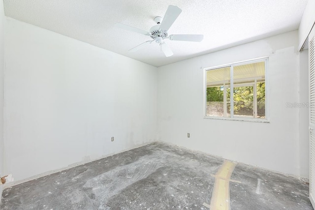 spare room with a textured ceiling and ceiling fan