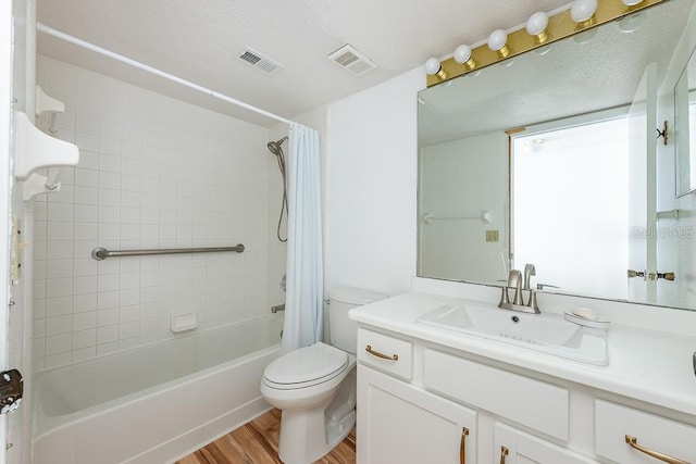 full bath with visible vents, toilet, shower / bath combo with shower curtain, and wood finished floors