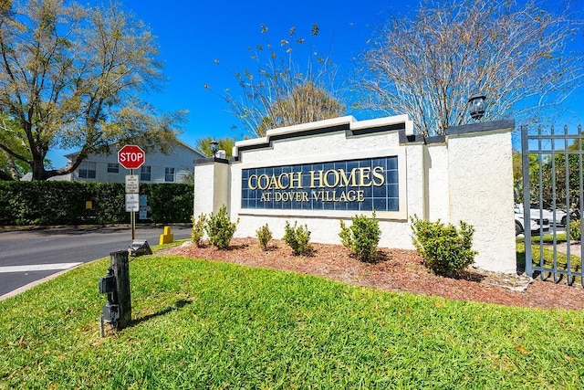 community sign featuring a lawn