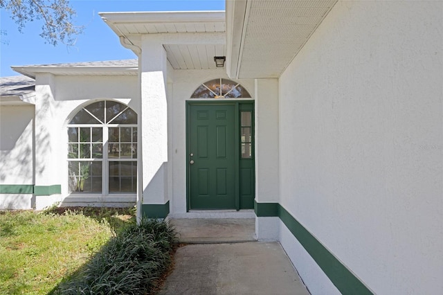 property entrance with stucco siding