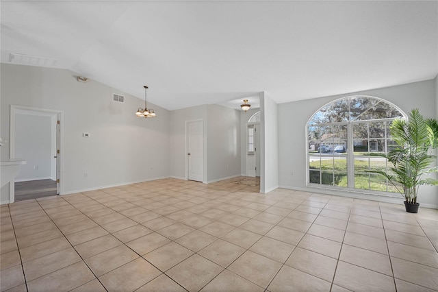 interior space featuring visible vents, baseboards, vaulted ceiling, light tile patterned floors, and an inviting chandelier