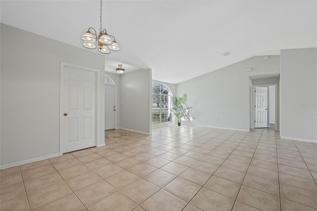 spare room with light tile patterned floors, baseboards, lofted ceiling, and a notable chandelier