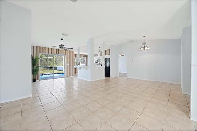 unfurnished living room with visible vents, baseboards, lofted ceiling, ceiling fan with notable chandelier, and light tile patterned flooring