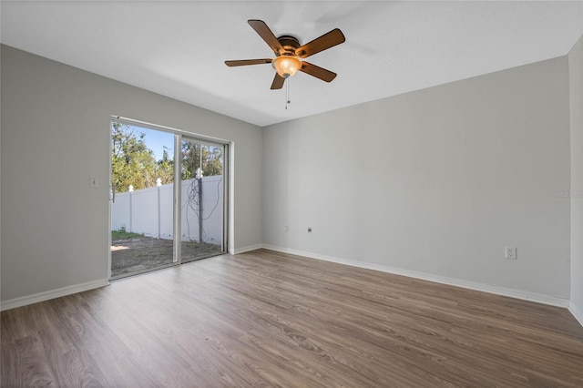 unfurnished room featuring wood finished floors, baseboards, and ceiling fan