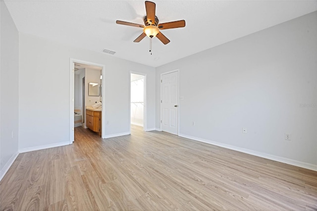 unfurnished bedroom with visible vents, baseboards, ceiling fan, light wood-style flooring, and ensuite bathroom