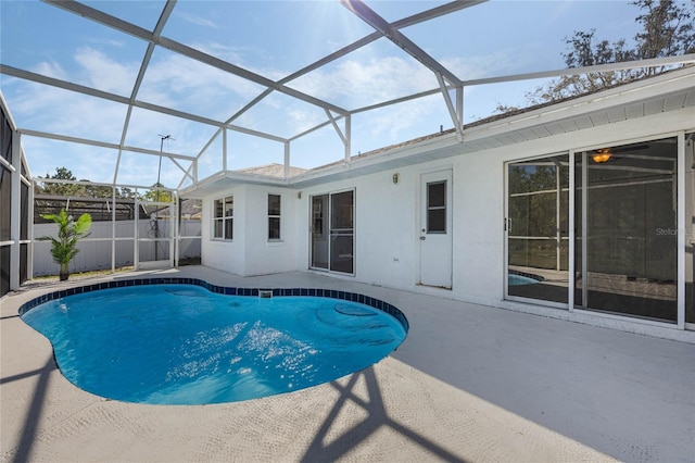 view of swimming pool with a patio, fence, a fenced in pool, and a lanai