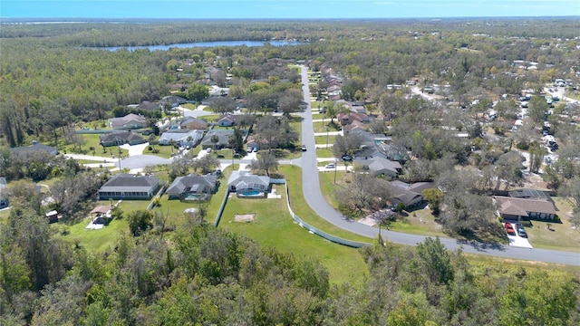 aerial view featuring a residential view, a forest view, and a water view