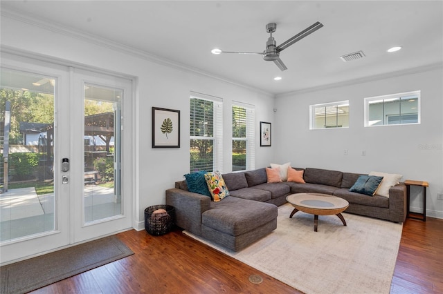 living room featuring visible vents, wood finished floors, and ornamental molding