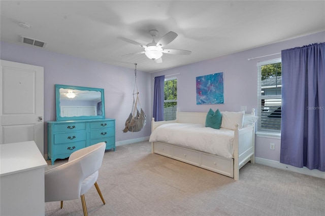 bedroom featuring visible vents, baseboards, light colored carpet, and ceiling fan