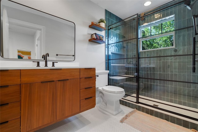 full bathroom featuring vanity, tile patterned floors, toilet, and a shower stall