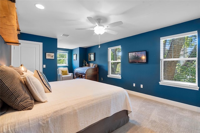 carpeted bedroom featuring visible vents, ceiling fan, and baseboards