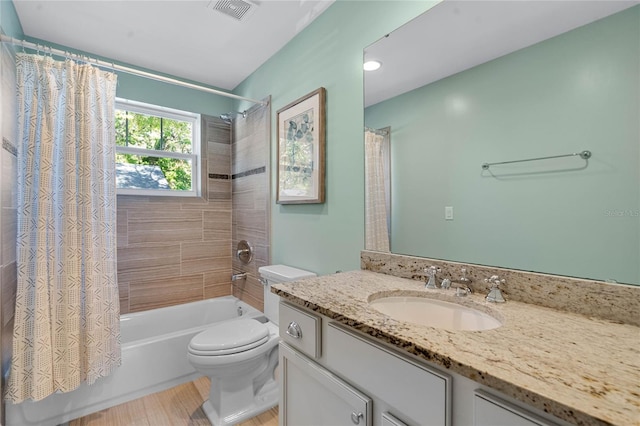 full bath featuring visible vents, toilet, shower / bath combo with shower curtain, and vanity