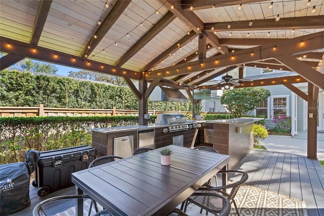 deck featuring a gazebo, outdoor dining area, area for grilling, and grilling area