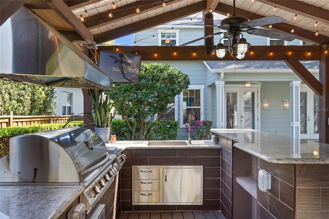 view of patio with ceiling fan, fence, french doors, a grill, and a sink