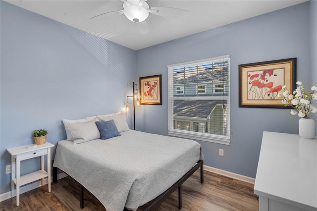 bedroom with baseboards, wood finished floors, and a ceiling fan