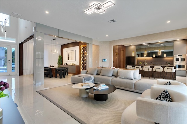 living room featuring recessed lighting and visible vents