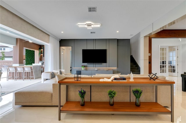 living room featuring visible vents, recessed lighting, and stairs