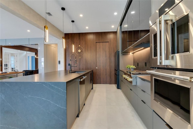 kitchen with a sink, stainless steel appliances, modern cabinets, and visible vents