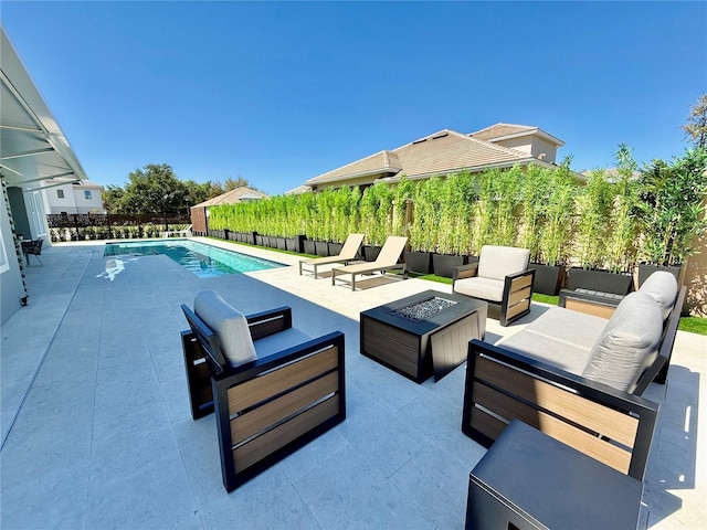 view of patio with a fenced in pool, an outdoor living space with a fire pit, and a fenced backyard