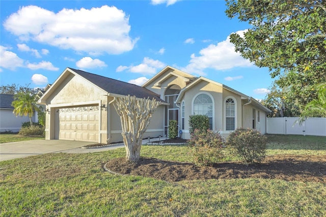 ranch-style home with stucco siding, a garage, concrete driveway, and a front lawn