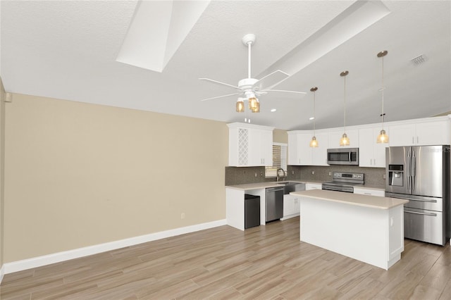 kitchen with visible vents, a sink, light countertops, appliances with stainless steel finishes, and backsplash