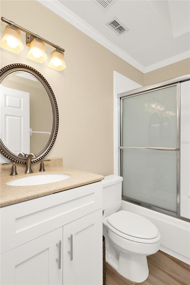 bathroom featuring crown molding, toilet, wood finished floors, and visible vents