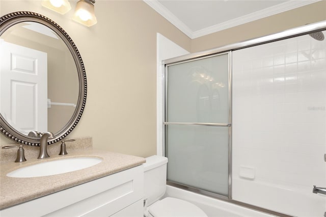 full bathroom featuring combined bath / shower with glass door, vanity, toilet, and crown molding