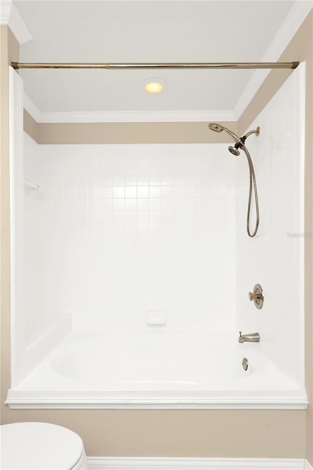 bathroom featuring  shower combination, toilet, and ornamental molding