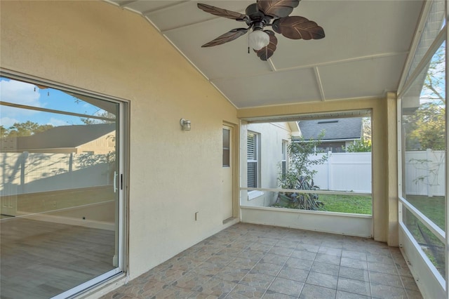 unfurnished sunroom featuring vaulted ceiling and ceiling fan