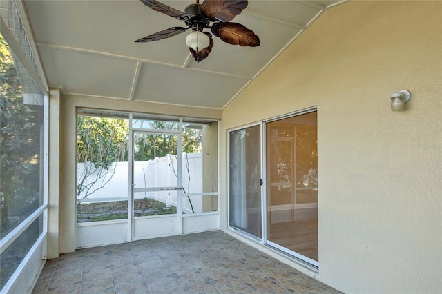 unfurnished sunroom with lofted ceiling and ceiling fan