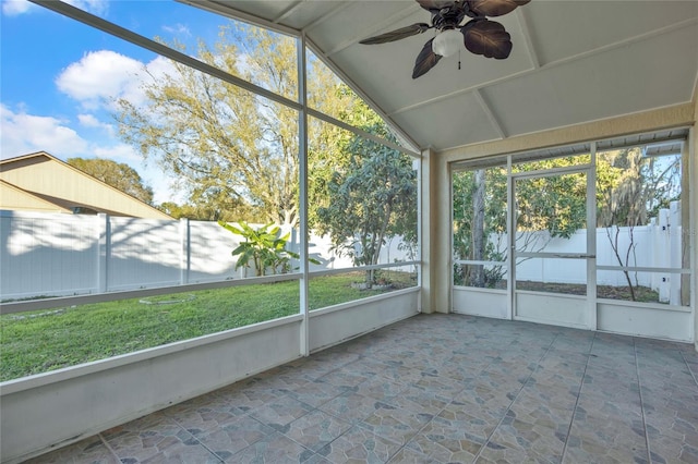 unfurnished sunroom featuring ceiling fan and vaulted ceiling