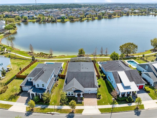 birds eye view of property featuring a water view and a residential view