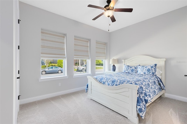 carpeted bedroom with baseboards and ceiling fan