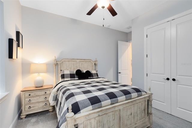 carpeted bedroom featuring a closet, baseboards, visible vents, and ceiling fan