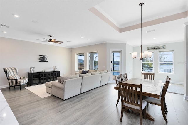 dining area featuring crown molding, visible vents, and a wealth of natural light