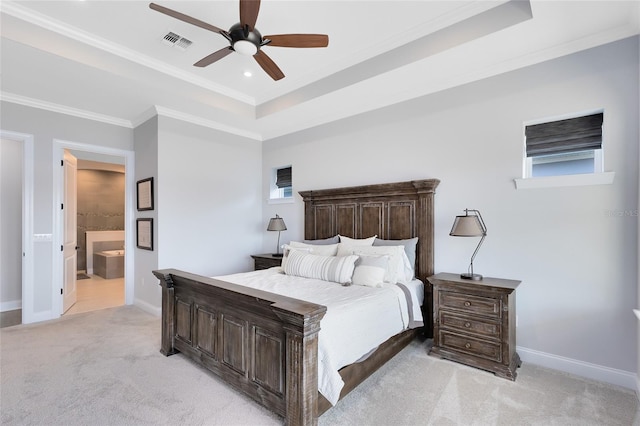 bedroom featuring visible vents, baseboards, a tray ceiling, ornamental molding, and light colored carpet