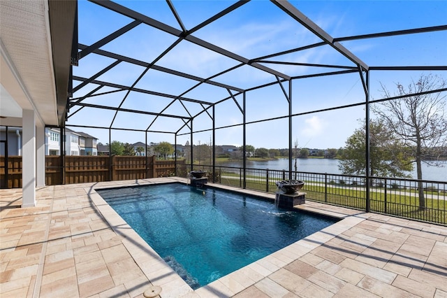 view of pool with glass enclosure, a patio, and a water view