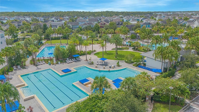 view of swimming pool with a patio area and a residential view