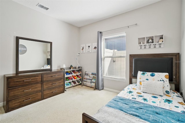 carpeted bedroom with visible vents and baseboards