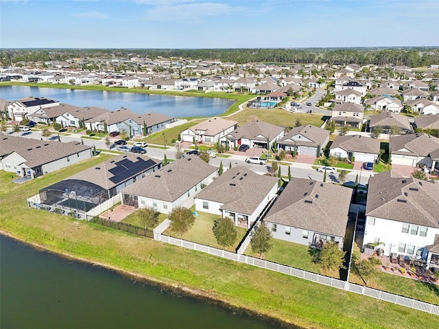 drone / aerial view featuring a residential view and a water view