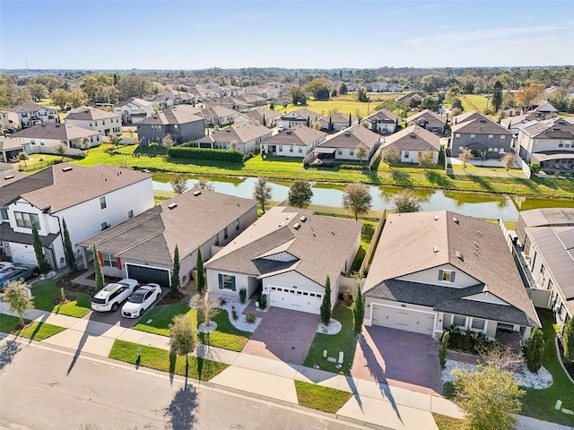 drone / aerial view featuring a residential view and a water view