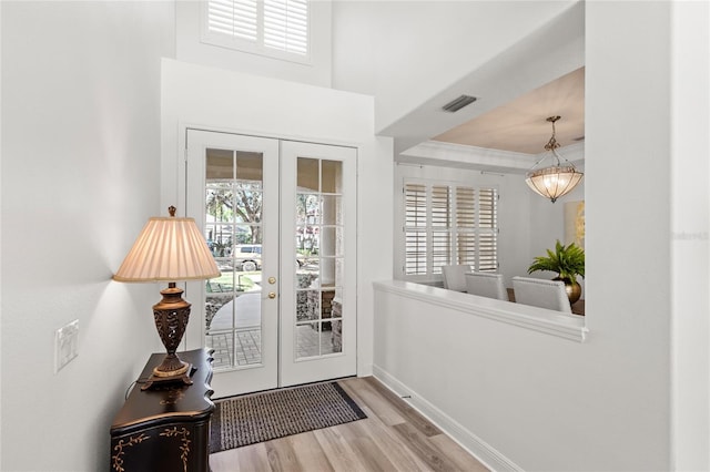 doorway featuring a wealth of natural light, visible vents, french doors, and wood finished floors