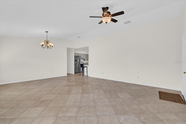 spare room featuring visible vents, baseboards, lofted ceiling, light tile patterned flooring, and ceiling fan with notable chandelier