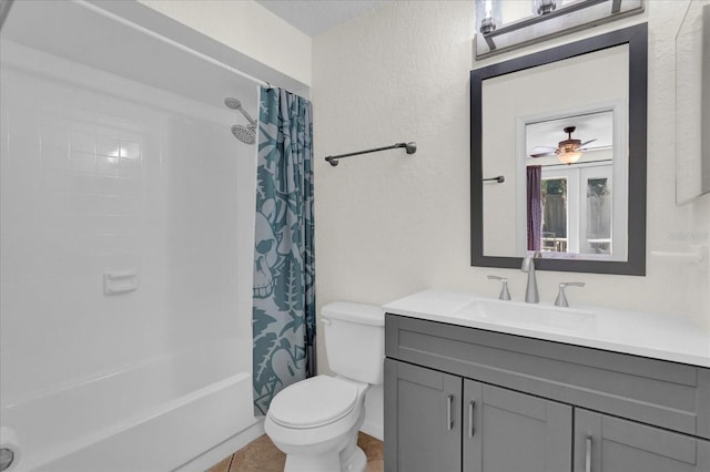 full bath with vanity, tile patterned flooring, shower / bath combo with shower curtain, toilet, and a textured wall