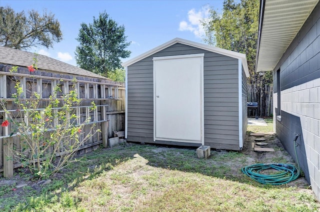 view of shed with fence